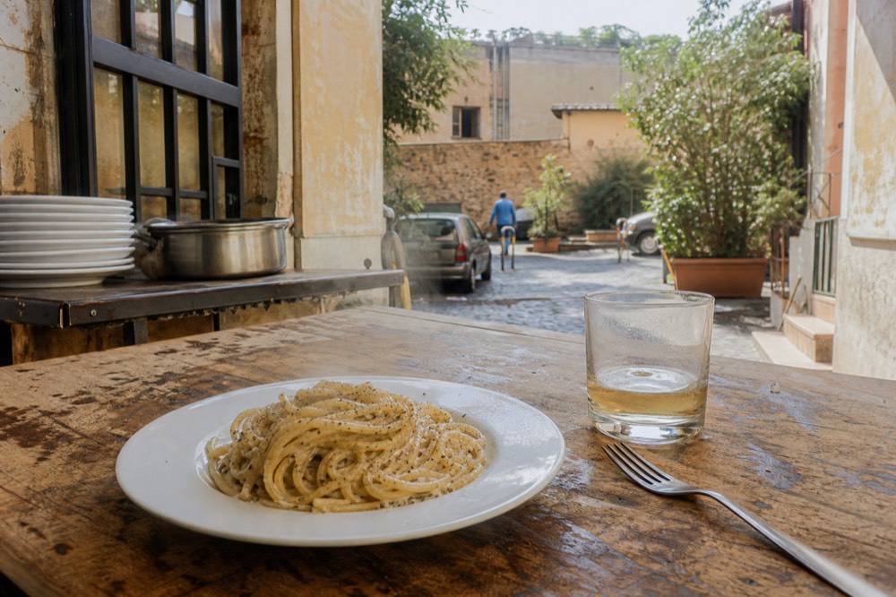 Handmade spaghetti plated with black pepper and pecorino sauce
