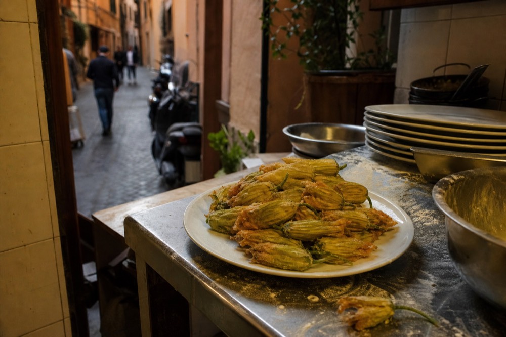 Fried zucchini flowers on a plate in a small trattoria