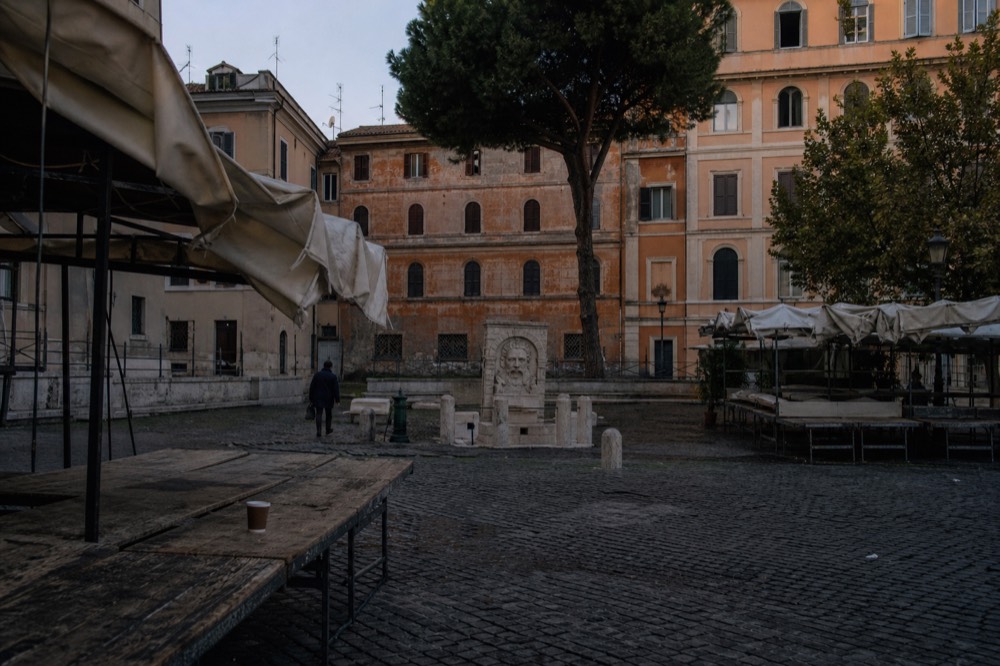 Early morning light on empty market benches before the day's trading begins